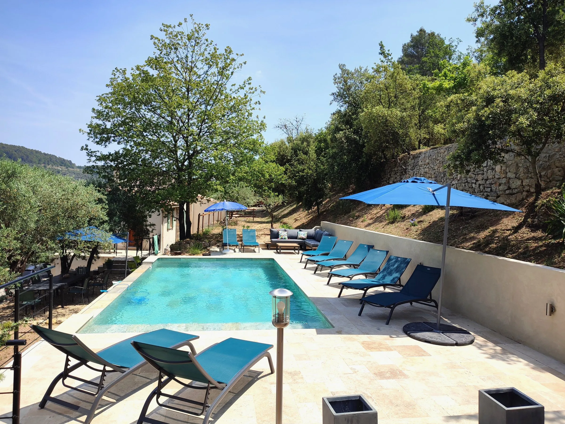 Pool and blue parasols in the late afternoon